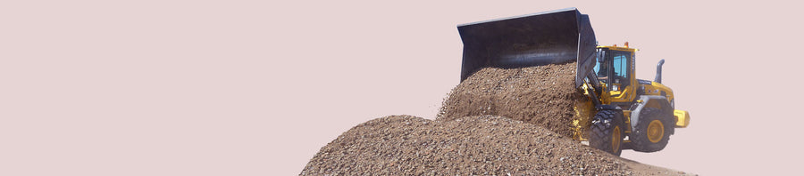 Een shovel bij een berg los gestort gebroken puin